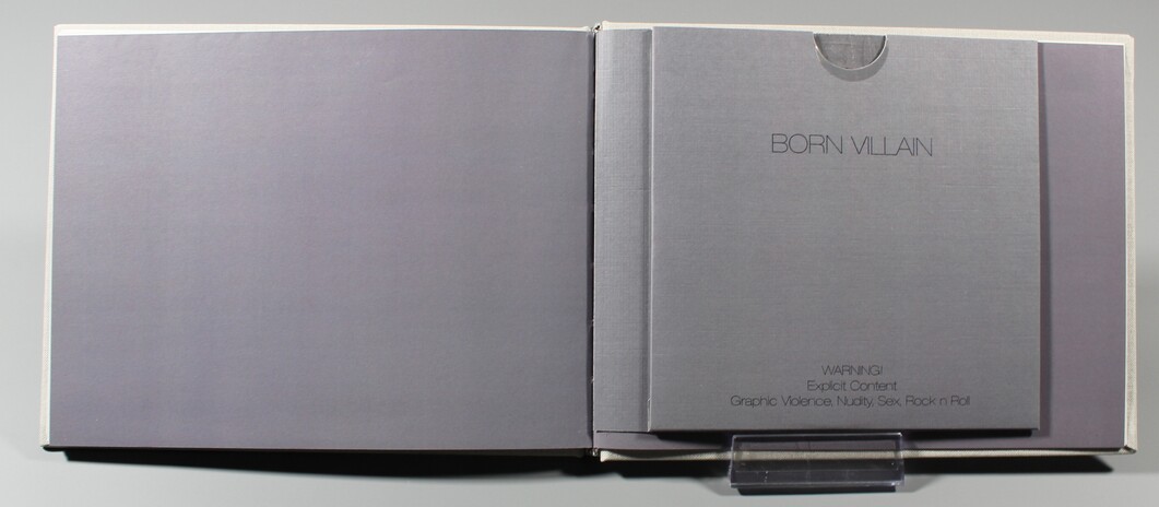 Interior of the cloth-bound presentation case with the Born Villain book housed in its fitted sleeve.